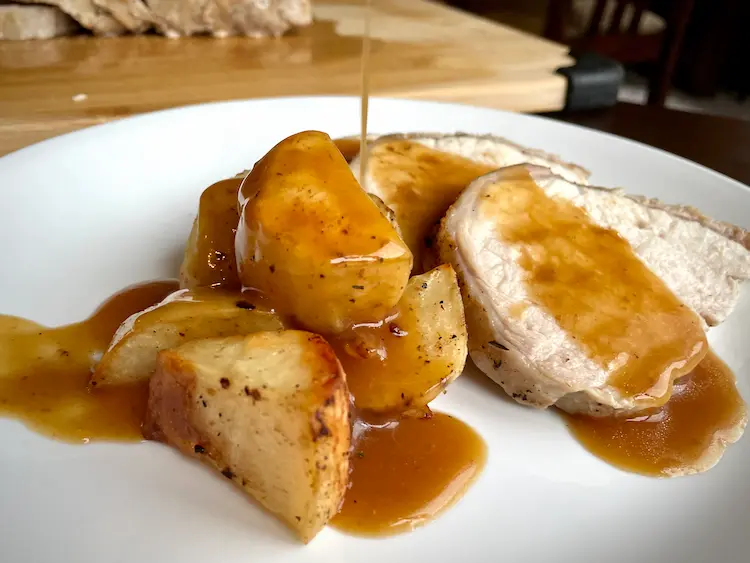 sliced pork roast with roasted potatoes and gravy sliced pork roast with roasted potatoes and gravy