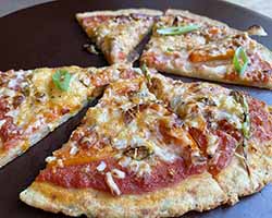 potato crust pizza topped with mushrooms, veggies and golden brown cheese.