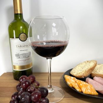 red wine with bottle beside bread and cheese