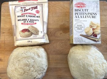 gluten free biscuit dough wrapped in plastic beside Duinkerken and Bob's Red Mill packages.