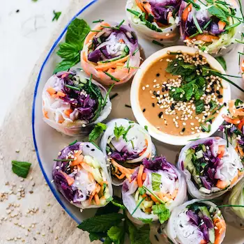 rice paper wraps beautifully displayed on a plate sprinkled with herbs