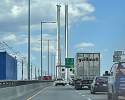 cars and trucks on a highway crossing a bridge