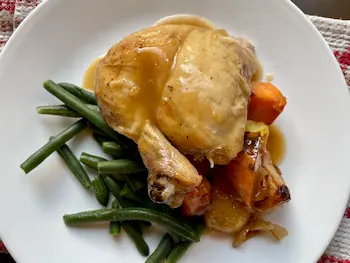 roast chicken plated with vegetables