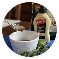 salad dressing with mustard, oil and balsamic vinegar in background