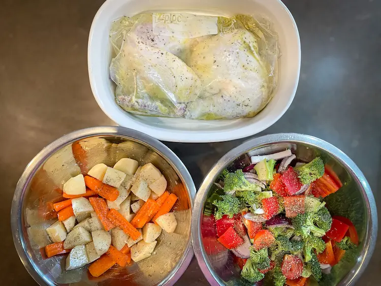 Chicken, vegetables and potatoes prepped to go on a sheet-pan