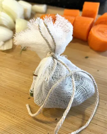 spice bag - bay leaf, parsley, peppercorns, garlic tied up in cheesecloth with a string. spice bag - bay leaf, parsley, peppercorns, garlic tied up in cheesecloth with a string.