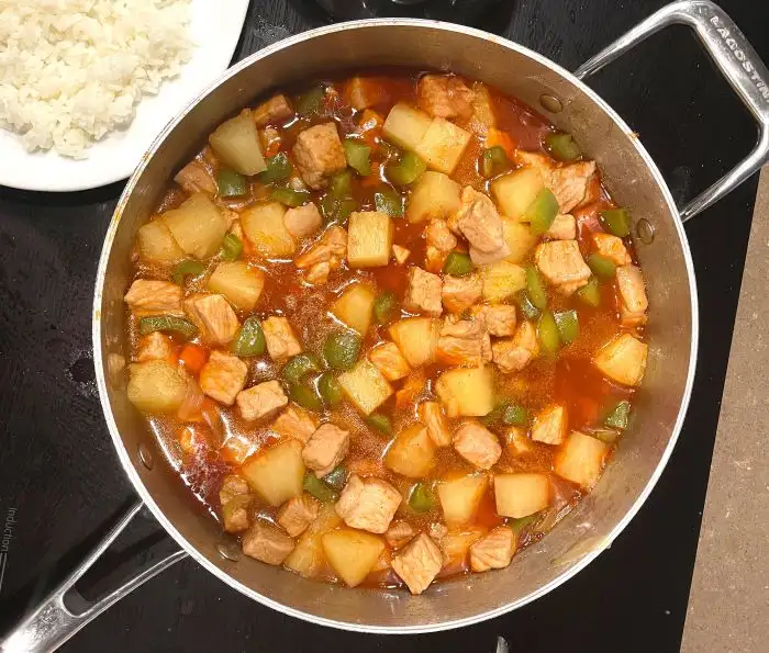 sweet and sour pork in pan with side of rice sweet and sour pork in pan with side of rice