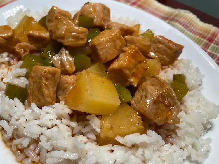 sweet and sour pork plated with rice
