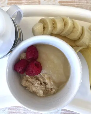 toddler breakfast of oatmeal, applesauce, raspberries and banana