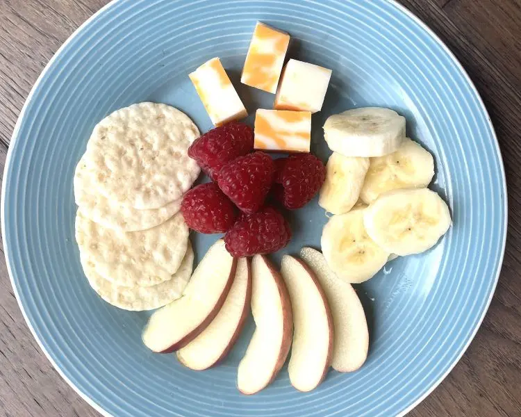 plate of cheese cubes, raspberries, apple slices and rice craskers plate of cheese cubes, raspberries, apple slices and rice craskers