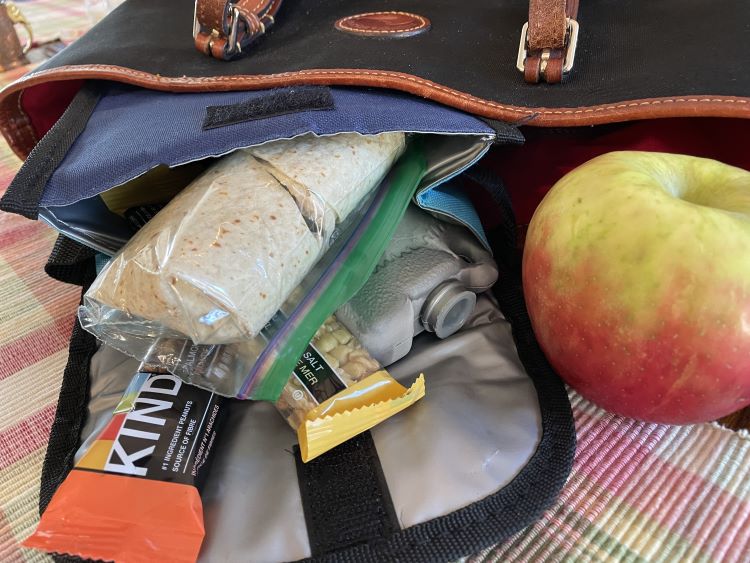 travel lunch - insulated lunch bag with granola bars, wrap and apple. travel lunch - insulated lunch bag with granola bars, wrap and apple.