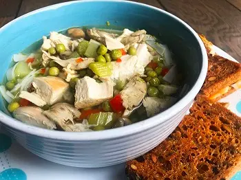 Homemade turkey soup with vegetable and gluten-free toast on the side.