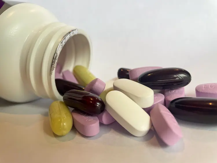 vitamin bottle with vitamins spilling out vitamin bottle with vitamins spilling out