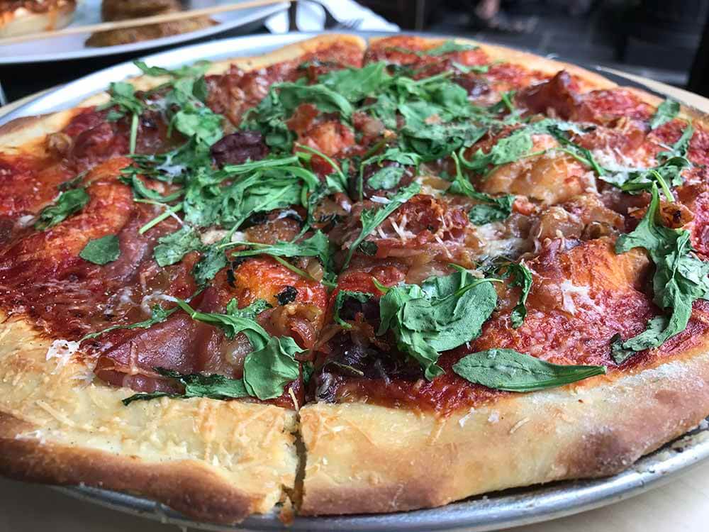 gluten-free pizza: whole pizza with tomato sauce, pepperoni and greens gluten-free pizza: whole pizza with tomato sauce, pepperoni and greens