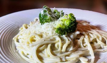 fettuccine Alfredo plated with broccoli